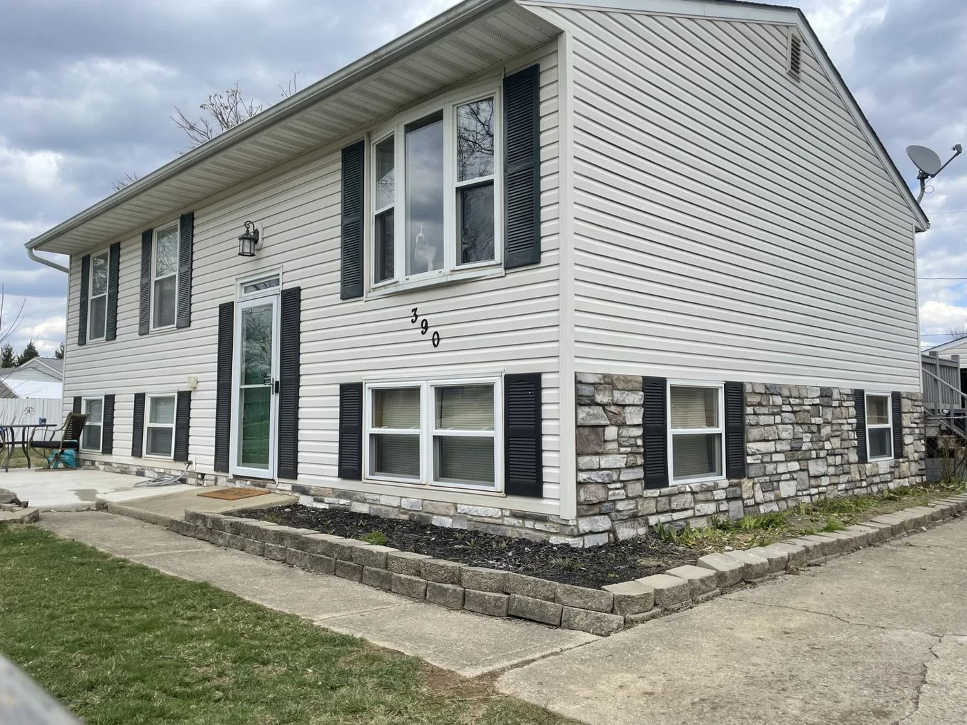 Home exterior with a cut stone base course