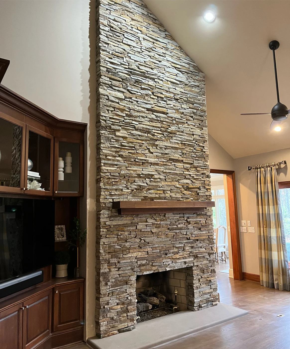 Corner stone fireplace running to the ceiling