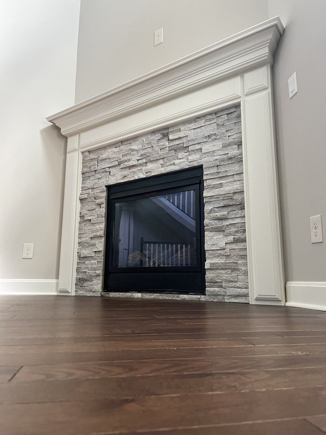 Stone firebox framed by a white painted mantel